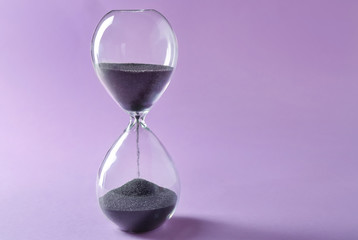 Hourglass on color background. Time management concept