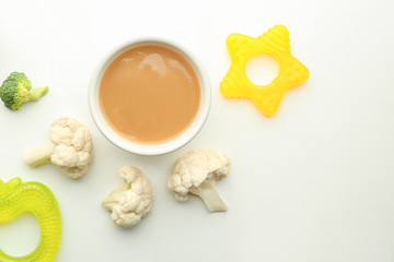 Flat lay composition with healthy baby food and ingredients on white background