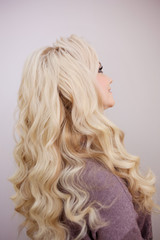 Back view of blonde with long luxurious curls.