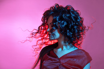 Femme fatale dancing, portrait in Studio with bright toning, blue and red color.