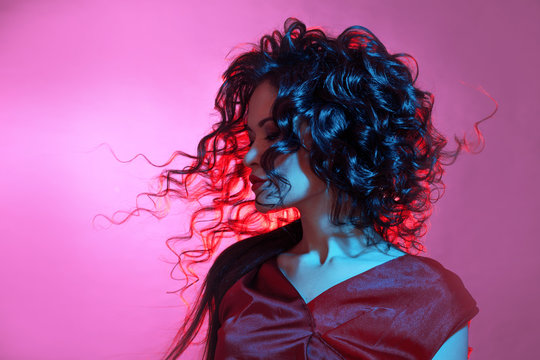 Femme fatale dancing, portrait in Studio with bright toning, blue and red color.