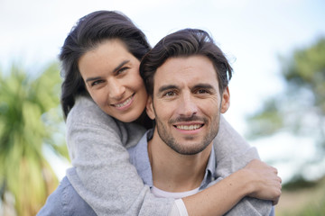  Portrait of gorgeous couple outdoors piggybacking