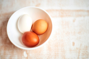 eggs in a bowl on wooden table