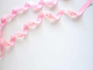 Pink curly ribbon on a  white