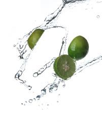 Limes with water splash or explosion flying in the air isolated on white background