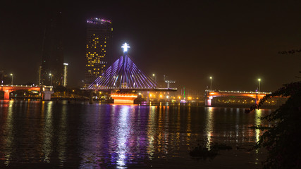 Fototapeta na wymiar Han river bridge in Danang is opening in the evening ligtining with different colors.Vietnam