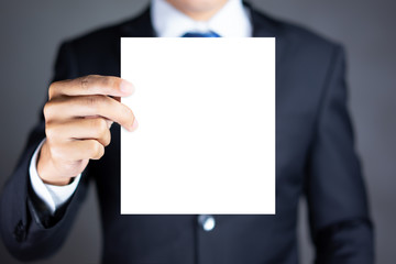 Businessman holding blank advertisement card with copy space
