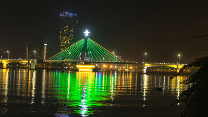 Fototapeta na wymiar Han river bridge in Danang is opening in the evening ligtining with different colors.Vietnam
