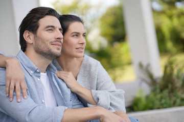 Fototapeta premium Portrait of very attractive couple smiling outside modern house