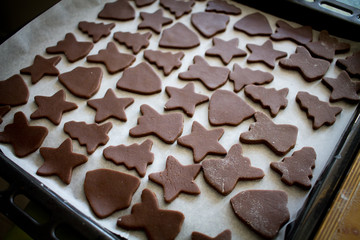 Christmas raw gingerbread cookies on baking tray.
