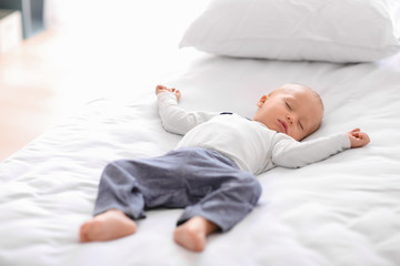 Cute little boy sleeping in bed