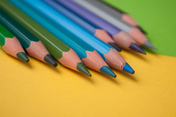 closeup of colouring pencils on color background
