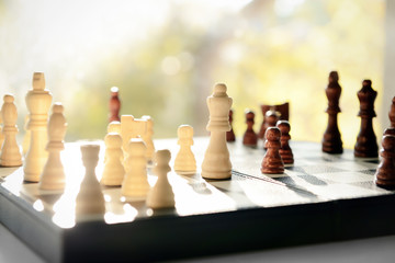 Game board with chess pieces on windowsill