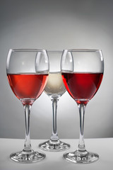 Glasses with different kinds of wine on grey table