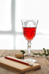 Glass of red wine on wooden table