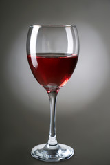 Glass of red wine on grey background