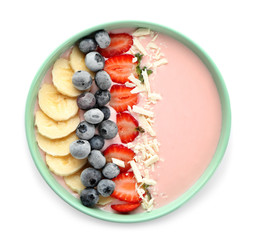 Bowl with pink yogurt and fresh fruits on white background