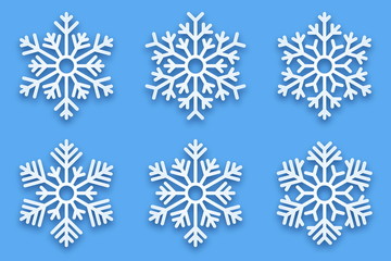 3D Vector Papercut Decorative Handmade Snowflakes Set with Soft Drop Shadow Isolated on Light Blue Background. Merry Christmas and Happy New Year Decoration Design Element