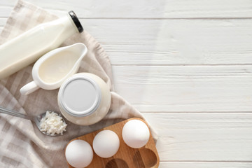 Different milk products on light wooden table