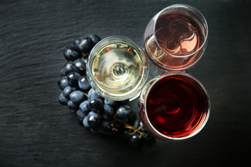 Glasses with different kinds of wine on dark background