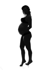 Artistic silhouette of blonde pregnant woman on isolated background