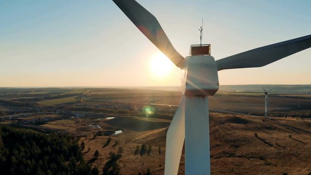 Wind generators working on a sunset background, close up.