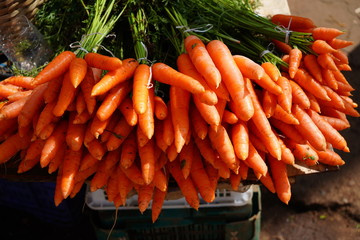 Bundles of organic carrots with the stems still attached