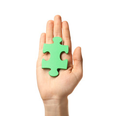 Woman with piece of color puzzle on white background