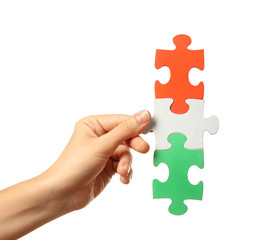 Woman with pieces of color puzzle on white background