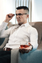 Exhausted ceo drinking whisky after unsuccessful meeting