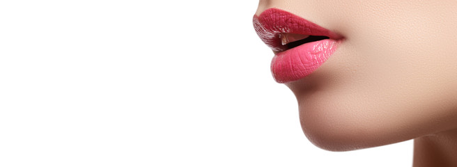 Close-up of woman's lips with bright fashion pink glossy makeup