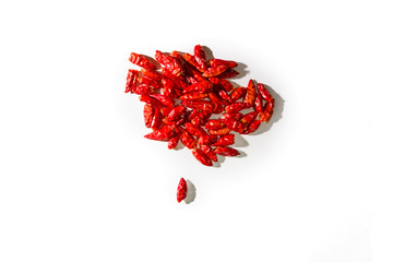 A pile of spicy chillies leaning on a white background