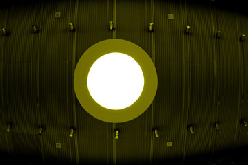 circle light on a metal ceiling