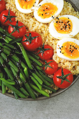 Colorful, healthy foods. flatlay. Buddha bowl with eggs, green beans and cherry tomatoes