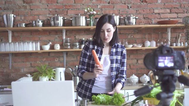 girl vegan blogger talks about vegetables on a webcam on the Internet