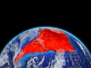 South America on planet planet Earth. Extremely detailed planet surface and clouds. Continent highlighted in red.