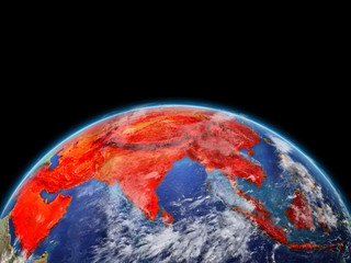 Asia on planet planet Earth. Extremely detailed planet surface and clouds. Continent highlighted in red.