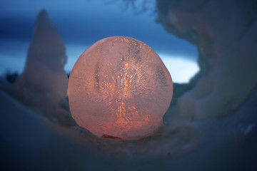 illuminated ice ball in the middle of snow