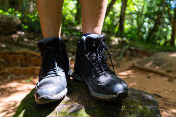 black hiking shoes walk to forest