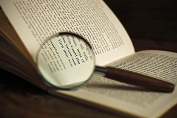 Fototapeta premium Book and magnifying glass
