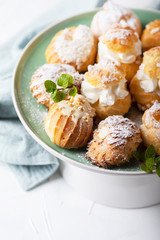 Delicious profiteroles with cream