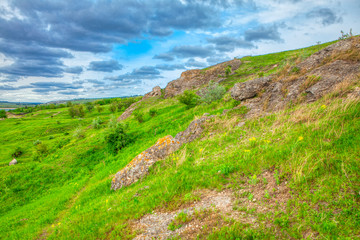 Fototapeta na wymiar green rocky hill spring scenery 
