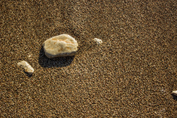 wet stones on sand sea shore background texture summer holidays vacation concept wallpaper, copy space