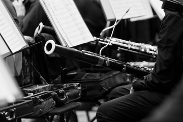 Bassoon in the hands of a musician in an orchestra in black and white closeup