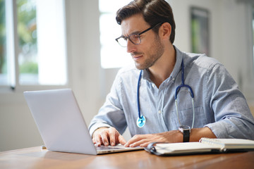 Fototapeta premium Handsome doctor in office