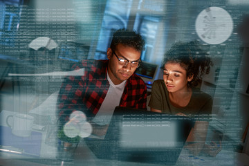 Young concentrated indian data analysts looking over the data