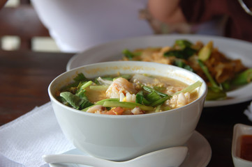 Tom yam soup in white bowl
