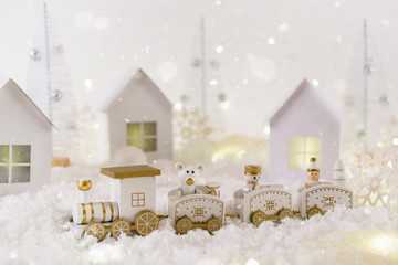 Frosty winter wonderland with toy train, snowfall and magic lights.  Christmas greetings concept, greeting card