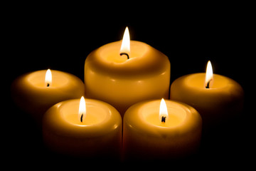 Burning candle in darkness
