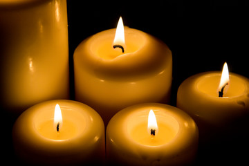 Burning candle in darkness